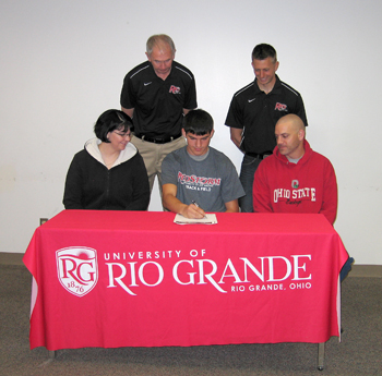 River Valley's Justin Mabe signs with Rio Grande as his parents and members of the Rio coaching staff look on